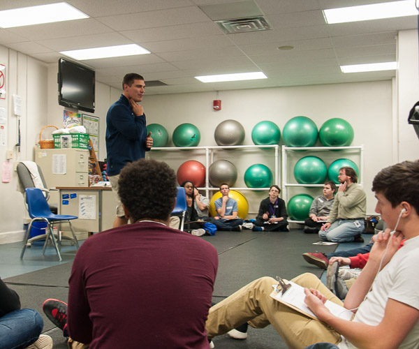 John M. Arrigone, part-time instructor of fitness and lifetime sports, leads students through a health assessment, first checking their heart rates.