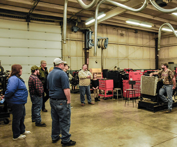 Diesel equipment technology instructor Claude T. Witts enlightens a labful at the Schneebeli Earth Science Center.