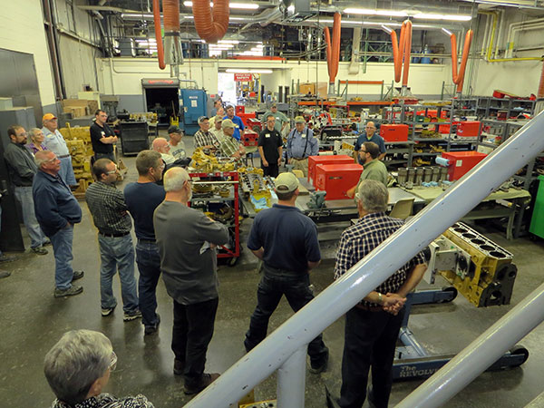 Justin W. Beishline (center right), assistant dean of transportation and natural resources technologies, leads a tour of the Schneebeli Earth Science Center labs during a reunion of diesel and heavy construction equipment technology alums.