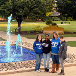 The officers and adviser of the Blue Crew campus-pride organization stand before the Veterans' Fountain, appropriately colored for Homecoming. From left are Jessica R. Wiegand, a business administration: marketing concentration major from Trout Run; Kacie L. Weaver, an applied human services student from Harrisburg; Allison A. Bressler, assistant director of student activities for programming and Greek life; and Emma J. Sutterlin, an applied health studies: occupational therapy assistant concentration major from State College.