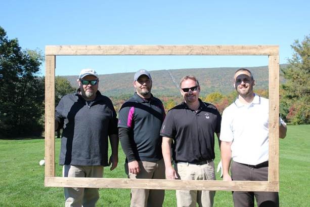 A team of plastic alumni fills the frame at the White Deer Golf Course. From left are 2002 graduates Kenneth L. Woodruff Jr. and James S. Hummer and, from the Class of 2015, Shawn R. Gum and Scott R. Bellum.