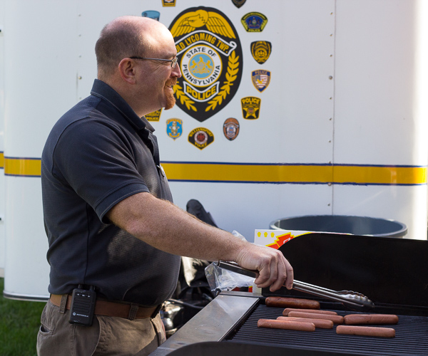 The menu isn't all food for thought, as Carl L. Shaner, director of college health services, tends the grill.