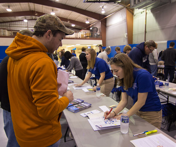 Presidential Student Ambassadors Morgan N. Keyser (foreground) and Victoria L. Kostecki were among the check-in volunteers walking campus guests through the day ahead.
