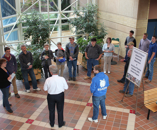 Timothy E. Weston, associate professor of plastics & polymer technology and department head, greets an interested crowd in the atrium of the Breuder Advanced Technology & Health Sciences Center.