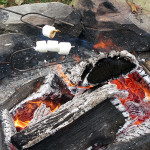 A cozy fire conquers the chill and coaxes gooey, golden-brown goodness from s'mores-in-waiting.