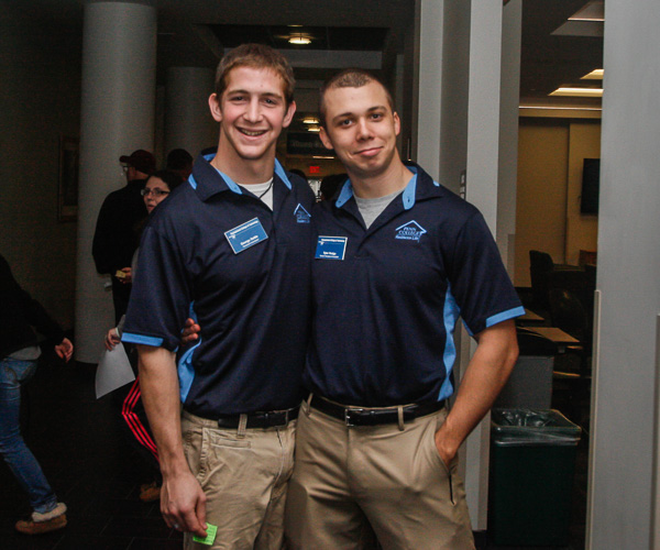 Gentlemen-in-waiting: Resident Assistants George W. Settle III (left) and Tyler D. Hodge stand ready to host their next housing tours.