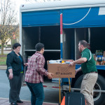 A heartened Sara H. Ousby watches as SGA President Zachary T. Peachey (center) and a Pepsi volunteer "Stuff the Truck."