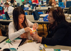 Jennifer Karetsky (left) and Dianne Haberstroh assemble a torch-style flashlight. Both are middle school science teachers in the Parkland School District in Allentown.