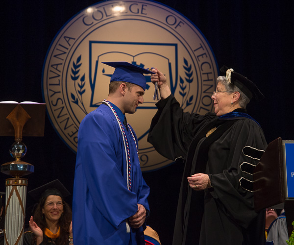 The president turns the tassel of the student speaker, who also received the President’s Award for leadership and service to the college. 