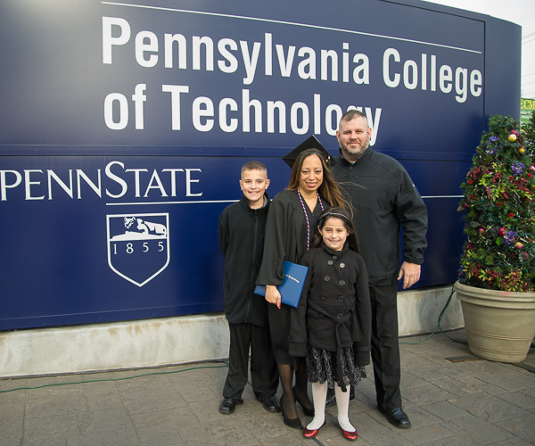 It’s never too chilly to pose at the big college sign! After commencement, new nursing graduate Brenda Applegate poses with her family. 