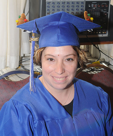 Emergency medical services graduate Kathy L. Kling, of Watsontown, sports seasonal accoutrement to the customary cap and gown: reindeer antlers – a suggestion from her 13-year-old daughter.