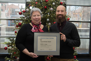 Penn College President Davie Jane Gilmour presented the Alumni Humanitarian Award to Jason C. Gross, ’05, plastics and polymer engineering technology, at winter commencement exercises held Dec. 19.