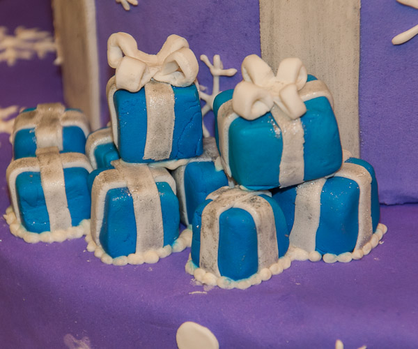 A pile of gift-wrapped boxes waits for Christmas on a cake by Jaclyn C. Gregg, of Warriors Mark.