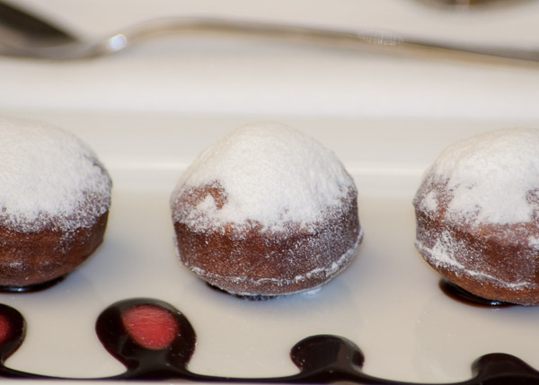 Krista A. Swinehart’s chocolate beignets with chocolate sauce and strawberry coulis.