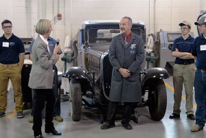 Diane Fitzgerald, executive director of the Hagerty Education Program at America's Car Museum, commends instructor Roy H. Klinger and students in the automotive restoration technology major during an October visit to Penn College.