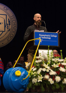Alumnus Jason C. Gross wheeled the Wello WaterWheel that he designed onto the Community Arts Center stage for his acceptance of the Alumni Humanitarian Award at Penn College’s winter commencement exercises.