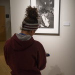 A student takes notes at the exhibit.