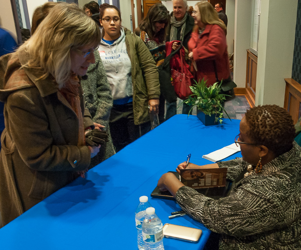Tutu signs a copy of her book, 
