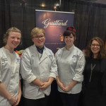 At Guittard’s trade show booth, from left, baking and pastry arts students Sarah I. Tielmann, of Tatamy; Lloyd A. Shope, of Blanchard; and Keegan D. Sonney, of Erie; with Laura Tornichio-Vidal, northeast territory sales manager for Guittard.