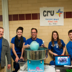 The Cru crew hands out cotton candy to fairgoers.
