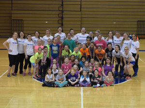 Penn College student-athletes (in white shirts) gather with the elementary-aged girls they championed in Saturday's daylong clinic.