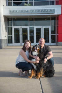 The Haldemans pose with their dog, Dunkin, in front of Madigan Library, where the couple exchanged wedding vows in May.