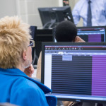 A prospective student explores the college’s “Interactive Broker” live brokerage software during a session led by Roy A. Fletcher, assistant professor of business administration/banking and finance.
