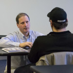 Mark A. Ciavarella, assistant professor of business administration/management, talks with a potential student during a “meet and greet.”