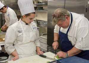 Churchill Downs Executive Chef David Danielson shows Penn College student Rebecca L. Klinger, of Cogan Station, how to trim vegetables for the college’s 2016 Visiting Chef Series dinner. Klinger is among 25 Penn College students interviewed and selected by Danielson to help prepare food at the May 7 Kentucky Derby.