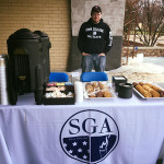 The Student Government Association's Benjamin L. Thayer, a residential construction technology and management student from Hampton, N.J., staffs a coffee-and-cookie table.