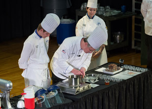 Chef Frank M. Suchwala, associate professor of hospitality management/culinary arts, and baking and pastry arts majors Jeffrey L. Bretz, of Williamsport, and Keegan D. Sonney, of Erie, practice one of the demonstrations for “A Taste of Technology” that they will present for Penn College at the USA Science and Engineering Festival. 