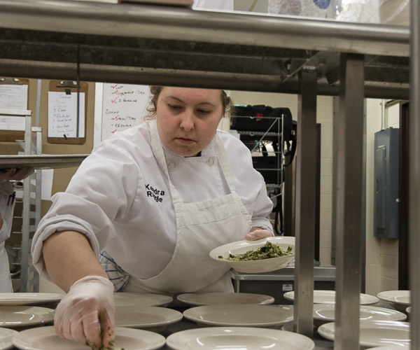 Student Kendra J. Riggle, of Montoursville, adds the base layer to the second course.
