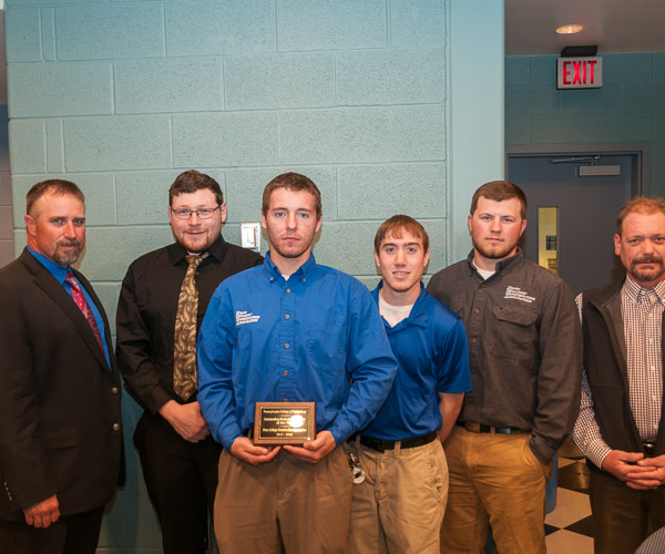 Members of the Penn College Construction Association, with co-advisers Levon A. Whitmyer (left) and Barney A. Kahn IV (right), claim the title as Outstanding Student Organization of the Year.