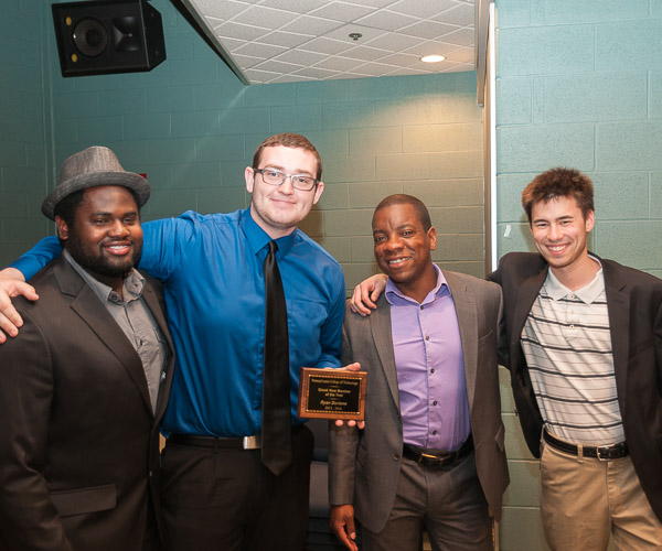 A trio of Sigma Pi brothers celebrates with Ryan P. Dortone, of Doylestown, an engineering design technology major honored as New Greek Member of the Year.