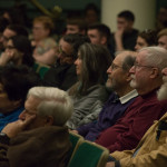Audience members sit rapt by the speaker’s storytelling. (Second from right is Daniel J. Doyle, for whom the colloquia series is named. He is seated between two retired English professors: Ned S. Coates to his right and Richard M. Sweeney.) 