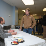 Construction management senior Shawn A. Mayberry, of Clarksburg, Md., talks with Bass at the post-lecture book signing and reception in Wrapture. 