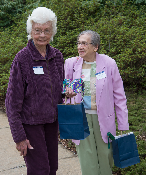 Joann Rishel (left), ’55, secretarial, and Constance Hess, ’58, secretarial, depart the Thompson Professional Development Center with their alumni goody bags.
