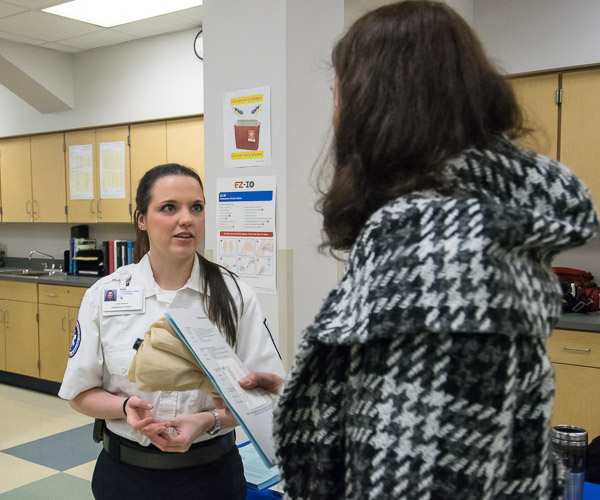 Emergency medical services student Loren M. Newman, of Wingate, talks with a visitor.