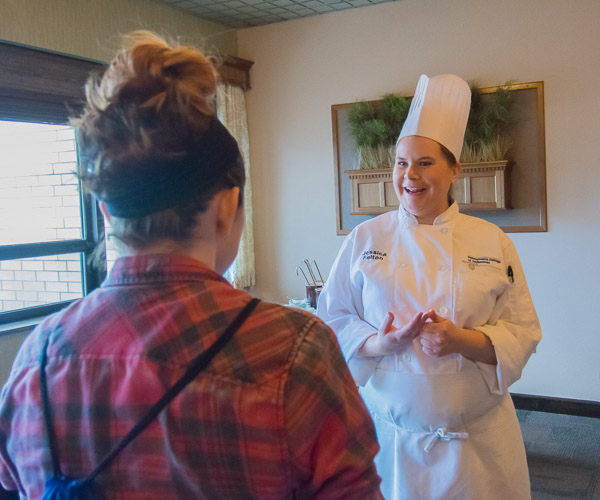 Appropriately stationed in Le Jeune Chef Restaurant, culinary arts and systems major Jessica N. Felton, of State College, talks hospitality careers.