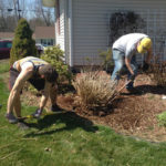 Caleb G. Schirmer (left), an applied management student from Sugarloaf, and Timothy L. Pegg, a welding and fabrication engineering technology major from Lexington Park, Md., spruce up a home's landscaping.