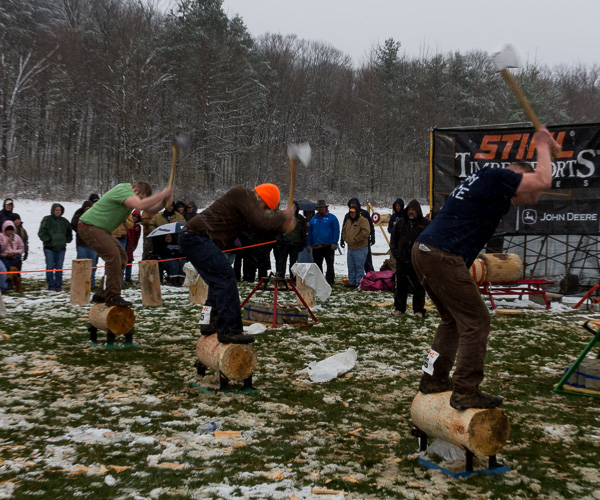 In contrast to the bundled-up spectators at Penn College's Timber Fest on Saturday, shirt-sleeve competitors wield axes in a competitive event.