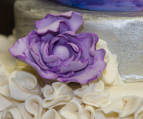 A painted purple rose adds delicate detail.