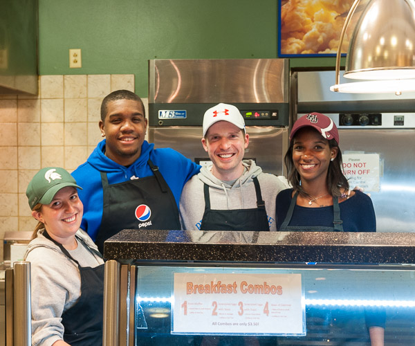 Counselor Brian J. Schurr (second from right) enjoys kitchen duty with (from left) Resident Life coordinators Rachael E. Vettese, Xavier J. Warner and Marceline Y. Salomon-Debrosse.
