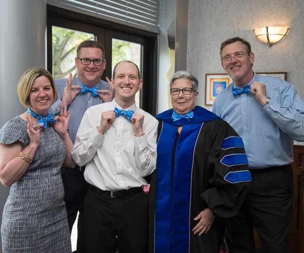 Planning a surprise for Friday's student speaker, an avid bowtie enthusiast, is this administrative crew of similarly accessorized supporters. 