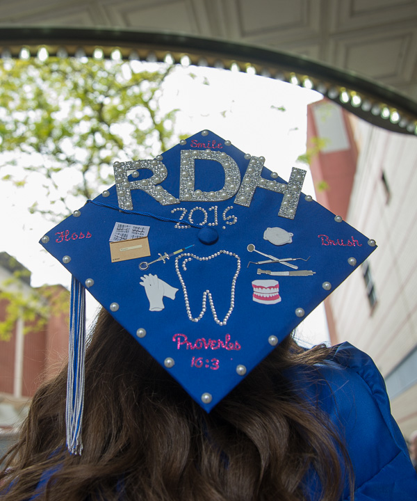 Decorations on a grad cap mimic the marquee’s lights.