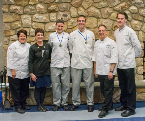 Top finishers in the Culinary Competition and Skills Assessment course capstone presentation –Jaclyn C. Gregg, of Warriors Mark, and Scott L. Neff, of Logantan (third and fourth from right) with, from left, course instructor Chef Mary G. Trometter, assistant professor of hospitality management/culinary arts; judge Chef Irene Maston, of Irene’s Cakes by Design; Chef Stephen J. Anania, ’90, culinary arts instructor at the Career and Technology Center of Lackawanna County; and Chef Charles R. Niedermyer, instructor of baking and pastry arts at Penn College.