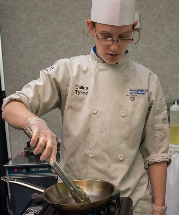 As part of the live-cooking event, Tyree begins to prepare samples.