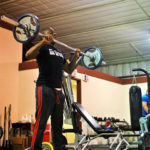 Shakeem J. Thomas, an emergency management technology major from Brooklyn, N.Y., lifts weights in the Field House.