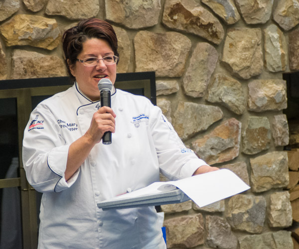 Chef Mary G. Trometter, assistant professor of hospitality management/culinary arts, announces scores for her class, Culinary Competition and Skills Assessment.