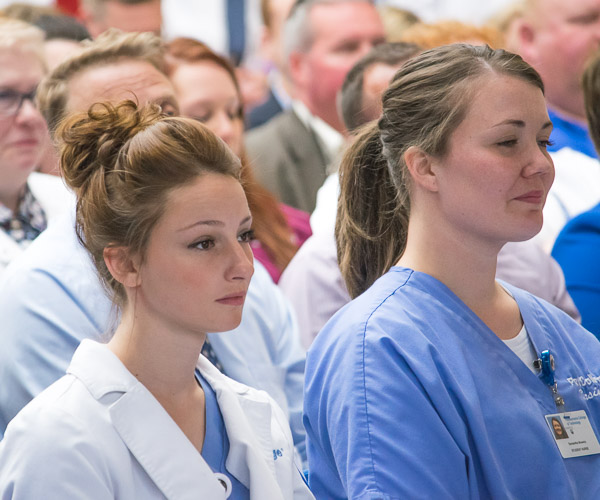 Nursing students listen to the words of graduates.